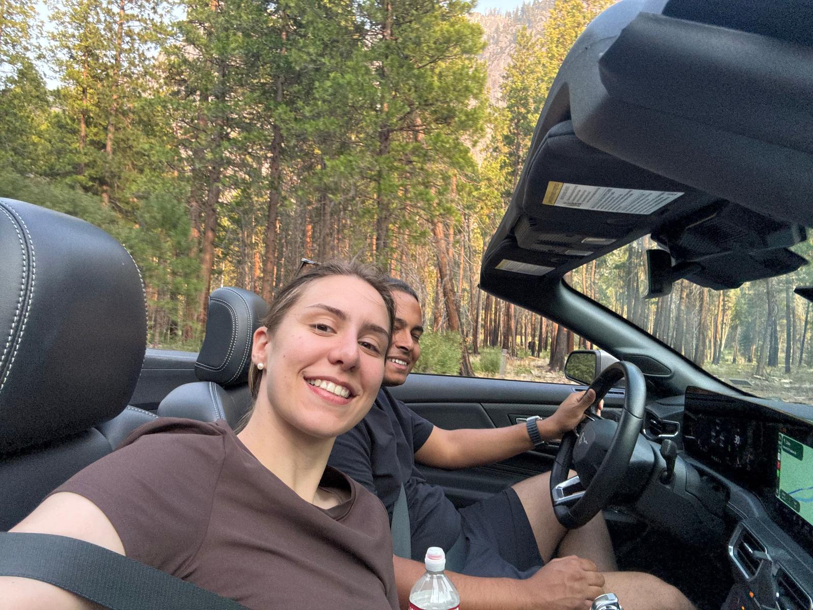 Driving a convertible Mustang through the forest