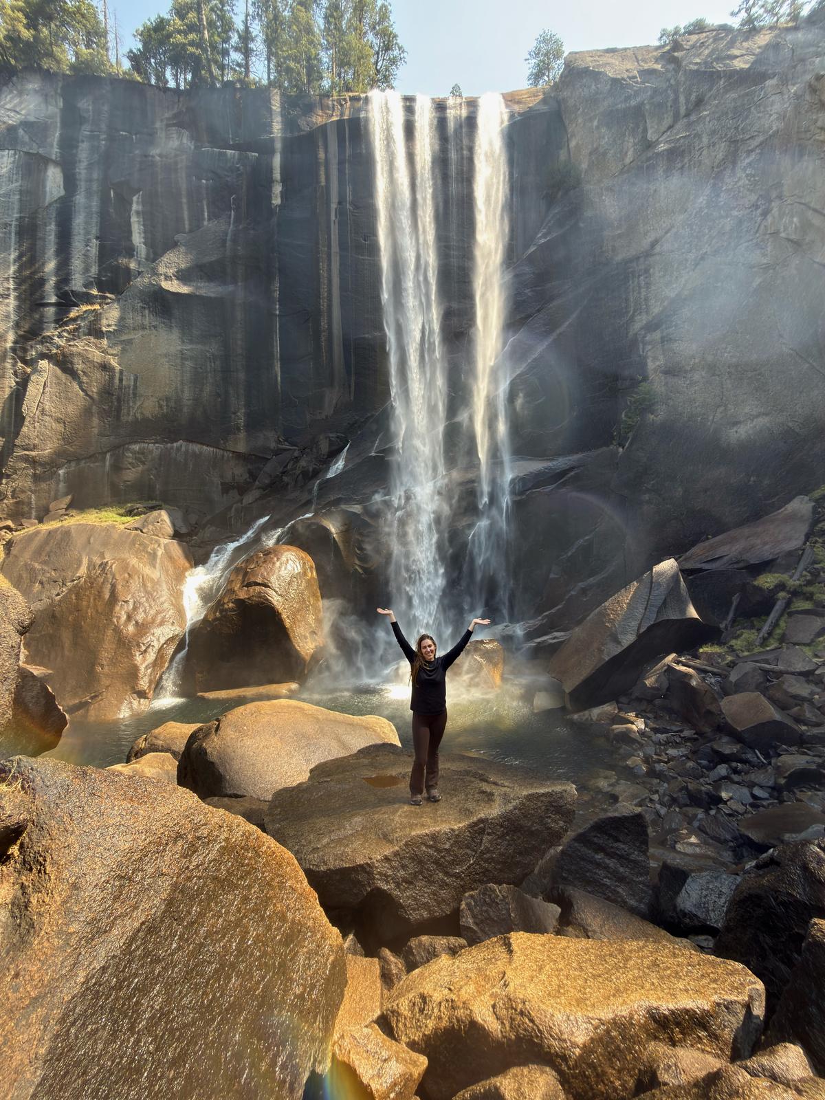 Lilien with her arms up in front of Vernal Fall
