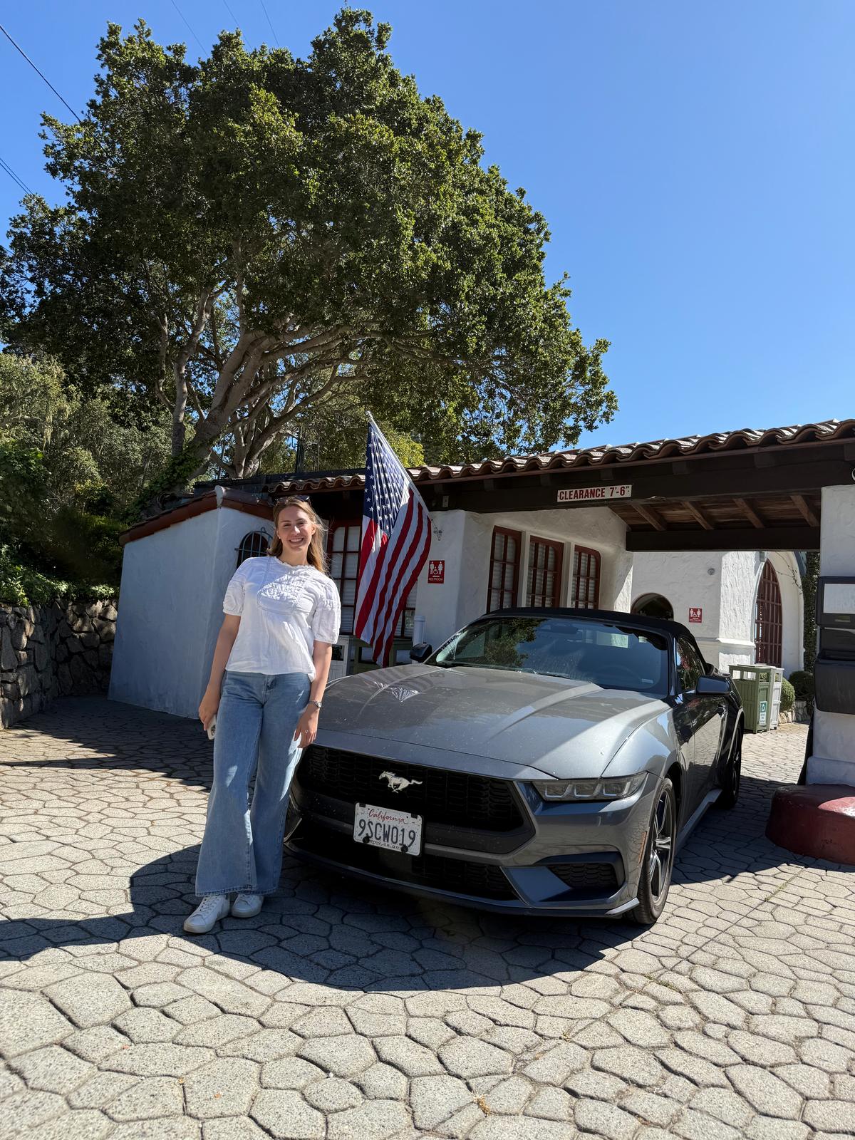 Lilien beside the silver Mustang