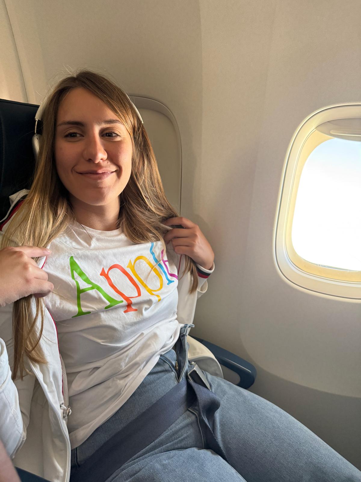 Lilien on the plane wearing an Apple t-shirt