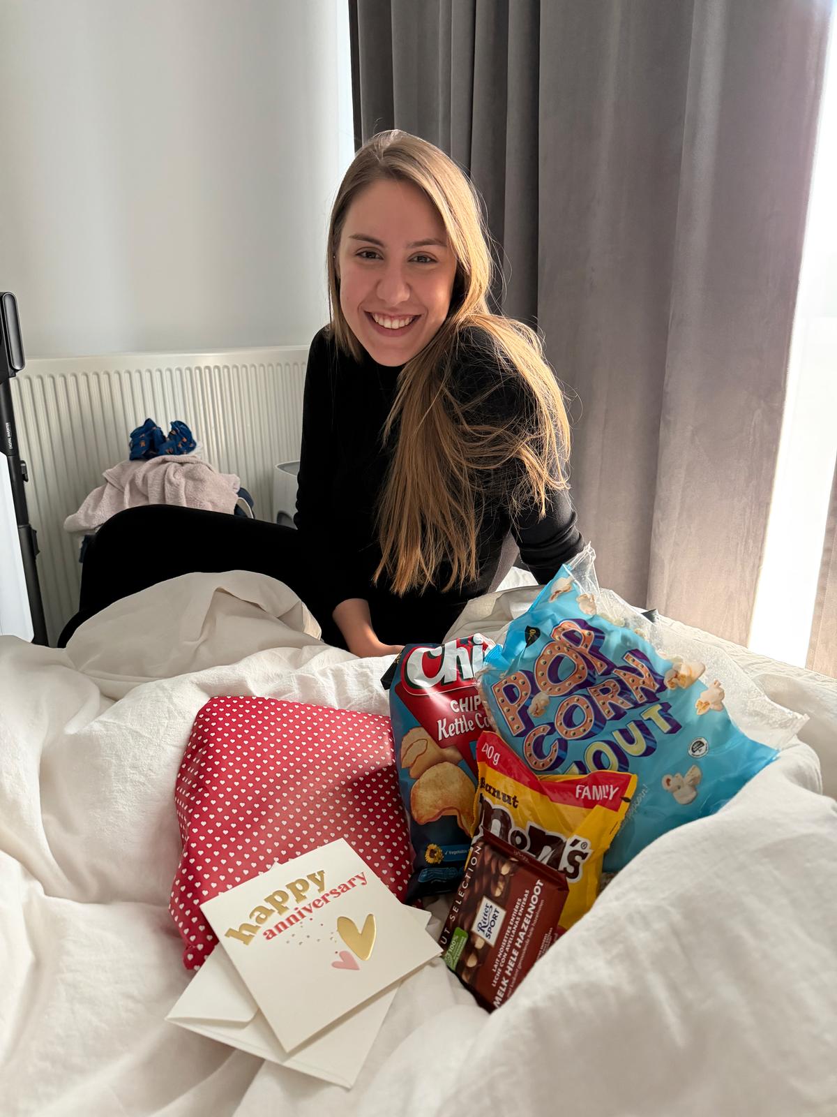 Lilien in bed with an anniversary card and snacks